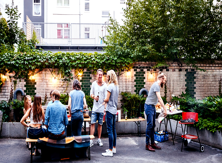 photo of group of people gathered in courtyard socialising